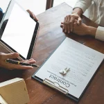 5-Year Warranty document next to a finely crafted table, symbolizing Investment Protection for Furniture Durability