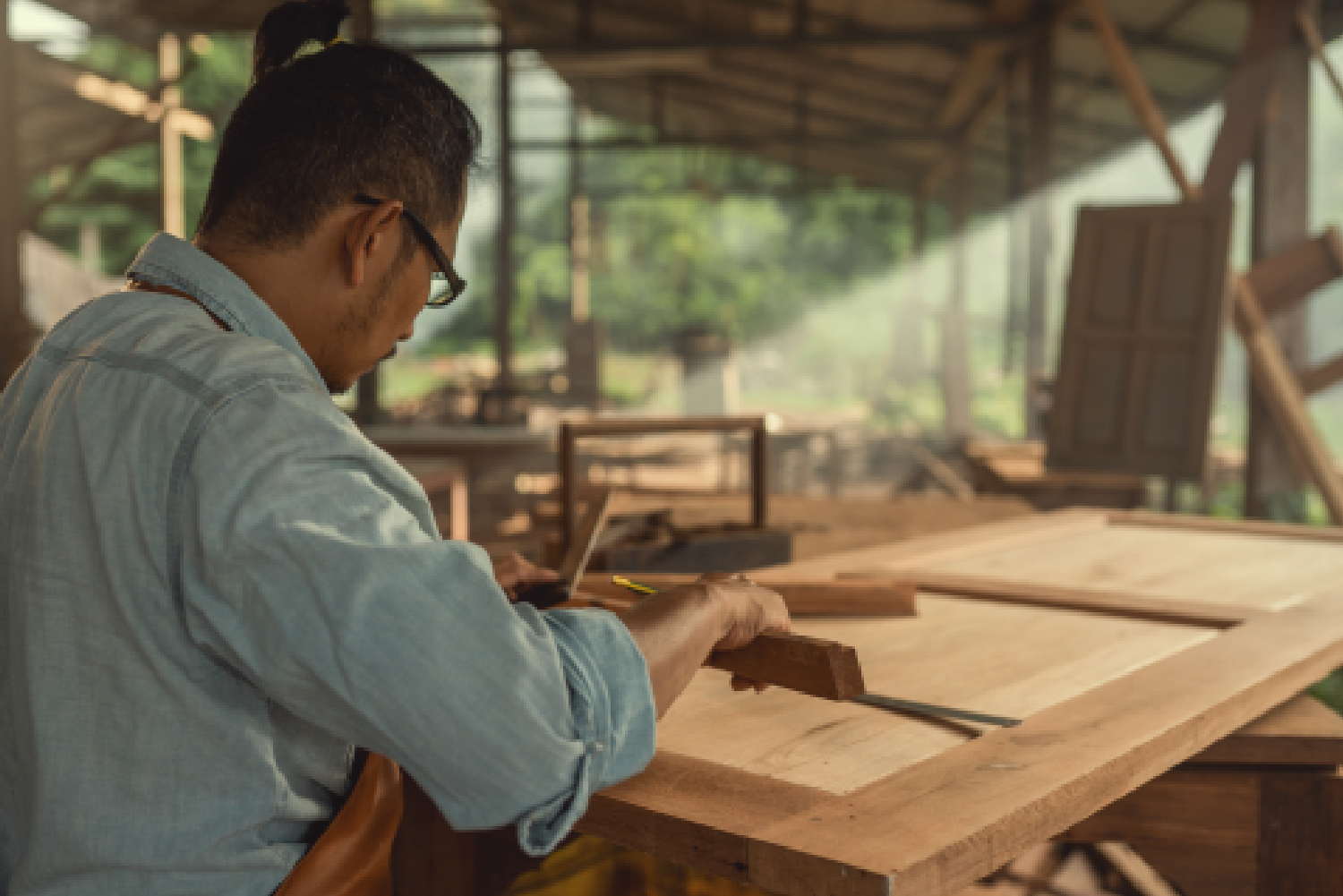 Technician inspecting Raw Material Quality during the rigorous Wood Selection Process before applying Anti-Warping Treatments